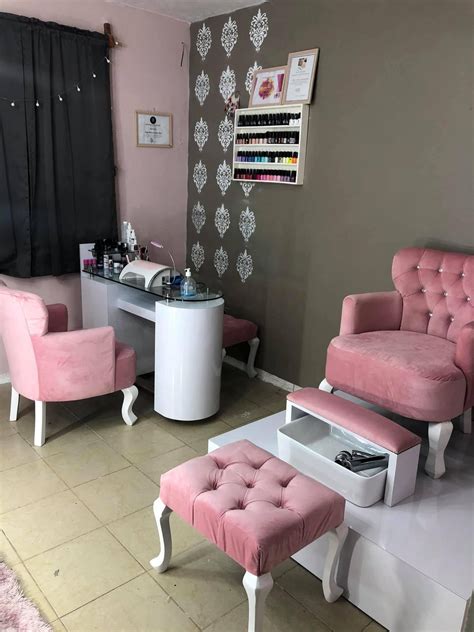 A Salon With Pink Furniture And Accessories On The Floor In Front Of A