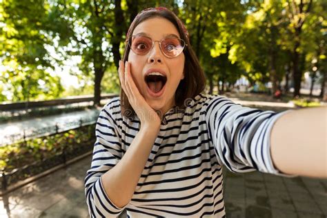 beautiful excited shocked woman outdoors take a selfie by camera stock image image of