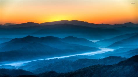 Golden Sunset Light Above The Blue Foggy Mountain Valley Wallpaper