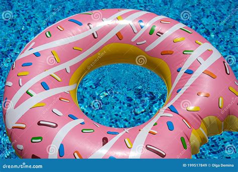 pink inflatable donut doughnut floating mattress in swimming pool beach pool accessories