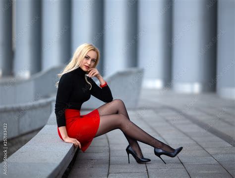 Beautiful Blonde Girl In Red Skirt With Perfect Legs In Pantyhose And