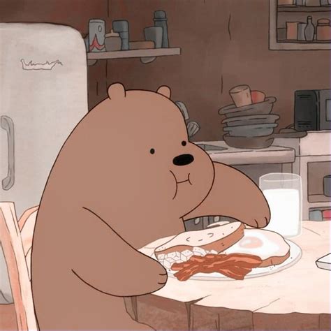 A Brown Bear Sitting In Front Of A Plate Of Food On Top Of A Table