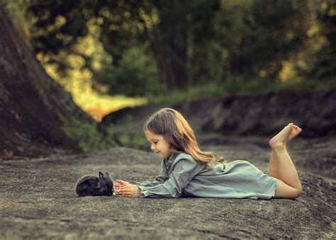 Little Girl Lying Down And Playing With Rabbit Wallpaperhd Cute