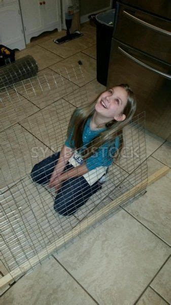 Young Laughing Girl Sitting In Wire Cage Carlos Cunha Model Release