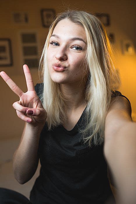 Beautiful Cheerful Teenage Girl Taking A Selfie In Bedroom By