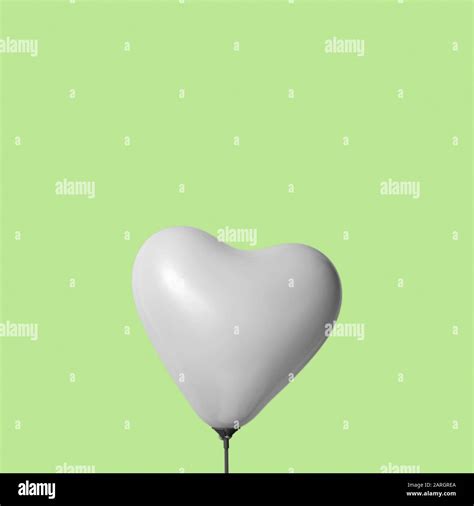 An Inflated Heart Shaped Balloon In Black And White Against A Green Background With Some Blank