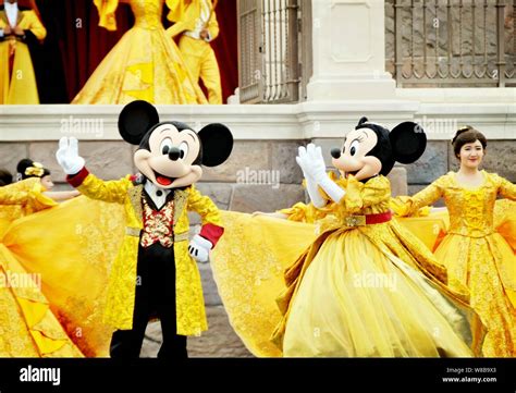 Entertainers Dressed In Mickey Mouse And Minnie Mouse Costumes Perform