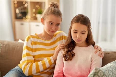 Teenage Girl Comforting Her Sad Friend At Home Stock Image Image Of