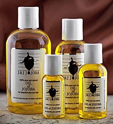 What black woman cannot remember sitting between her mother's legs as she parted, combed, brushed and (sometimes brutalized) our hair? How to Use Jojoba Oil for Dry Scalp - Dryscalpgone.com