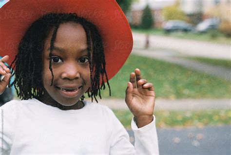 Smiling Black Girl With Red Hat By Stocksy Contributor Gabi Bucataru Stocksy