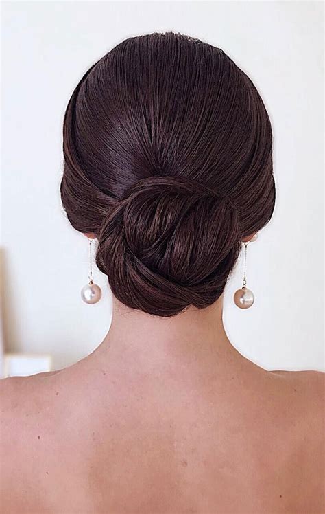 It's cute, creative and one of the most adaptable medium wedding hairstyles. Classic sleek low bun Updo - Elegant Wedding Hairstyles