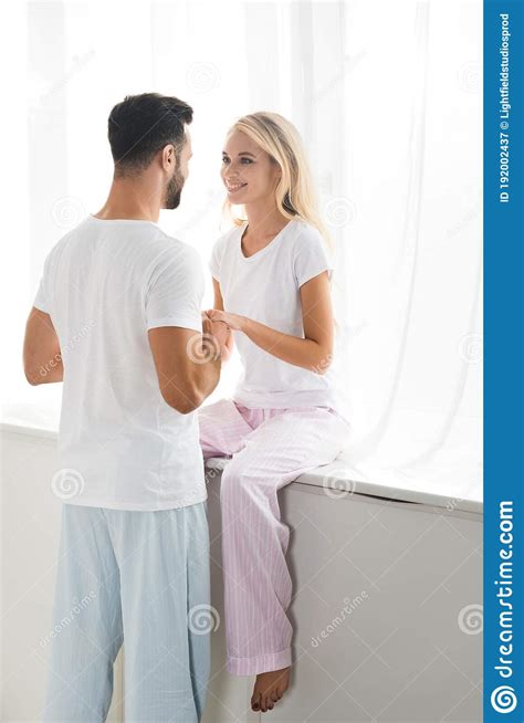 couple in pajamas holding hands at home in bedroom stock image image of sunshine attractive