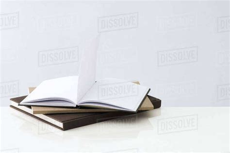Stack Of Books One Open Book With Blank Pages Inside Stock Photo