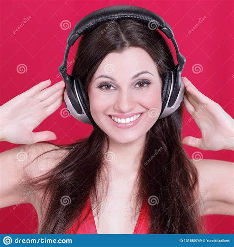 Cheerful Young Woman Listening To Music Through Headphones Stock