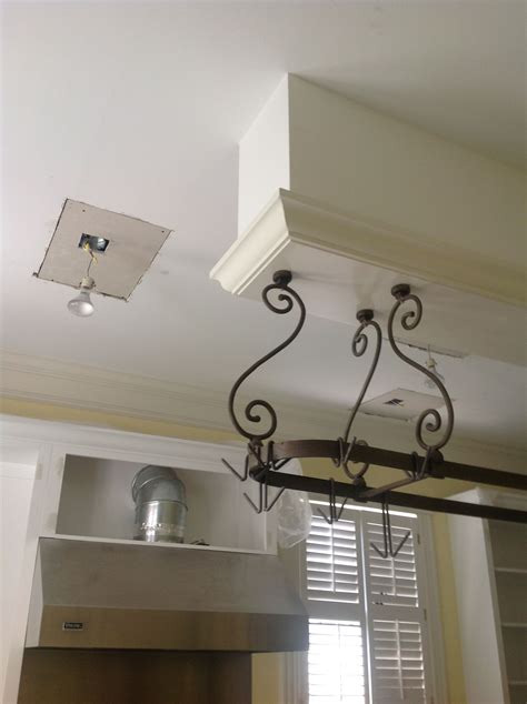 Learn how to organize your pots, pans, and lids in your kitchen. Ceiling under construction.....love the hanging pot rack ...