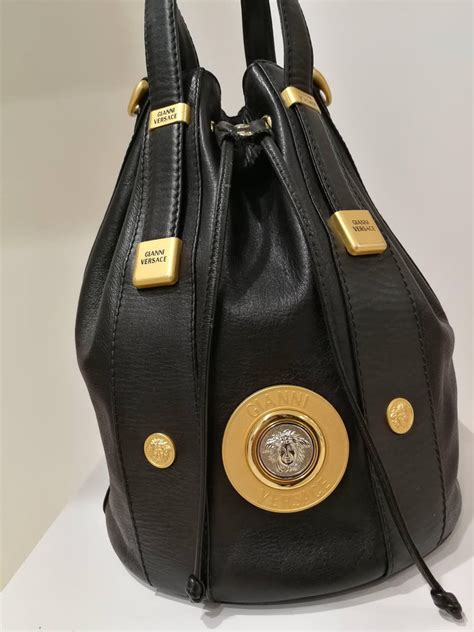 It comes with an adjustable long 60 inch shoulder it comes with an adjustable long shoulder strap to comfortably fit the tall and the short. Gianni Versace Black leather Gold and Silver Tone Studs ...