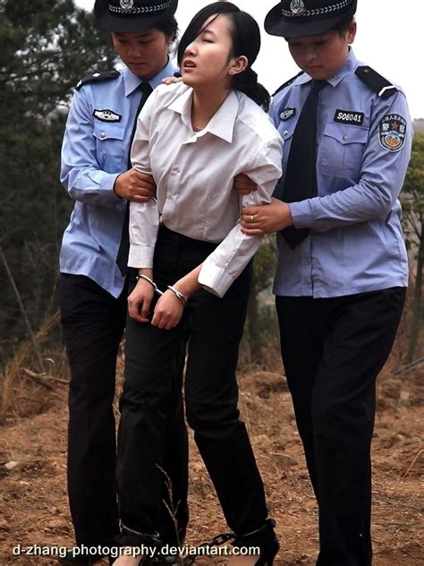 Woman In Handcuffs And Leg Irons Attended By Female Chinese Police