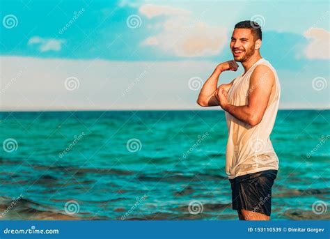 Closeup Portrait Of Handsome Man On The Beach In Mild Sunset Light