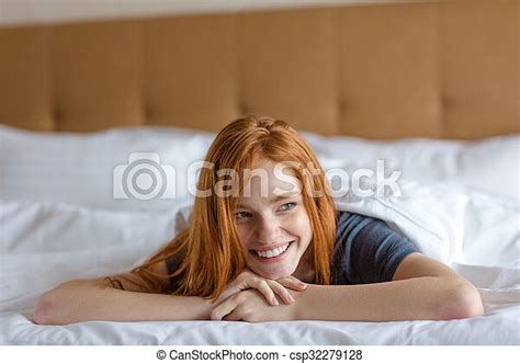 Smiling Redhead Woman Lying In The Bed Portrait Of A Smiling Redhead Woman Lying In The Bed And