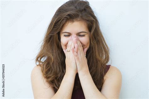 Embarrassed Girl Laughing And Covering Mouth With Hands Pretty Young Woman With Brown Hair