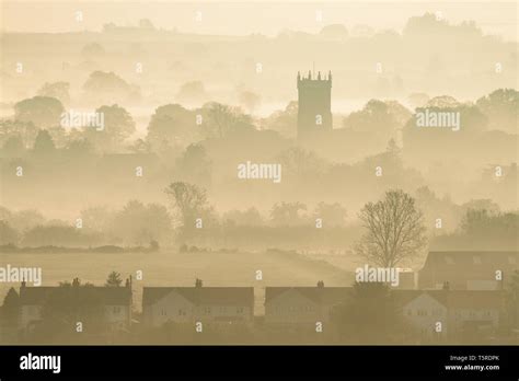 A Misty Sunrise Over The Village Of Kingsbury Episcopi On The Somerset