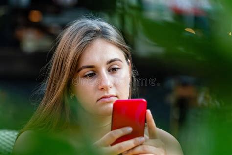 Young Woman Using Mobile Phone Communication Looking At Digital