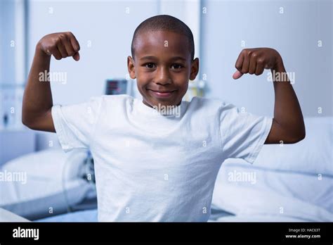 Portrait Of Boy Flexing His Muscles In Ward Stock Photo Alamy