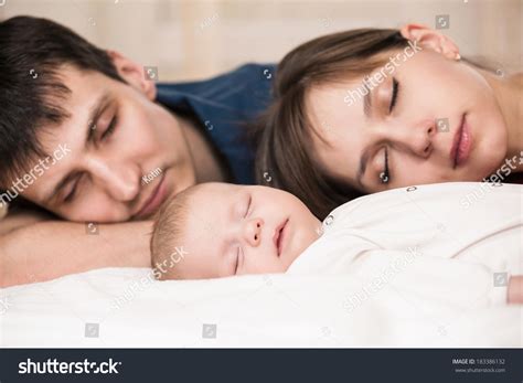 Sleeping Baby With Mom And Dad Closeup Stock Photo 183386132