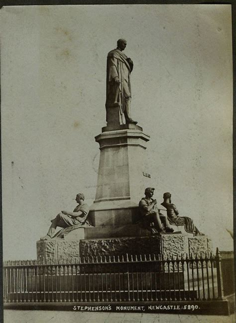 An Old Black And White Photo Of A Statue In Front Of A Fence With
