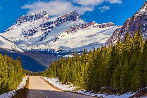 Road In The Background Of Snow Capped Mountains Banff