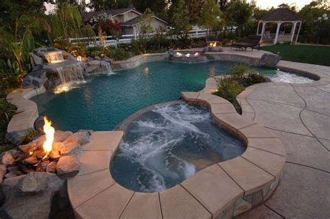 Tropical Inground Pool With A Hot Tub And Waterfall Waterfalls