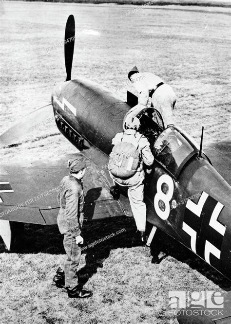 A Pilot Of The German Luftwaffe Climbs Into A Combat Aircraft Of The