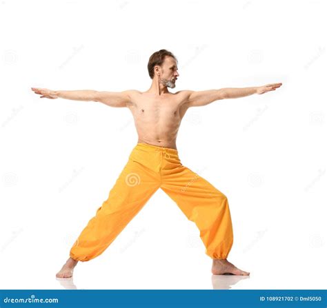 Old Man Practicing Yoga Doing Sport Stretching Exercises In Yellow