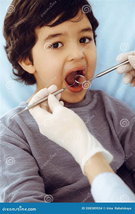 Little Arab Boy Sitting At Dental Chair With Open Mouth During Oral