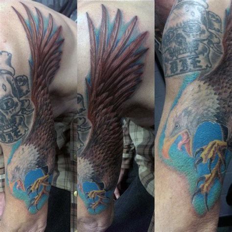 Man With Brown Feathered Bald Eagle Tattoo And Skull Future Tattoos