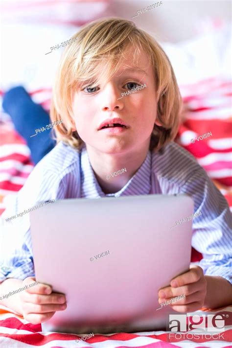 7 Year Old Boy Using Tablet Computer Stock Photo Picture And Rights