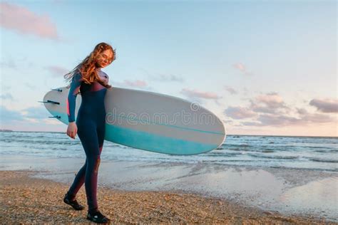 Beautiful Surf Girl With Long Hair Holding Surfboard Go On Beach At