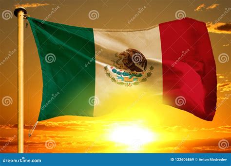 Mexico Flag Weaving On The Beautiful Orange Sunset With Clouds