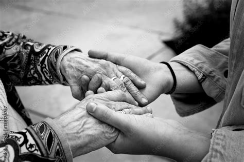 Young Hands Supporting Old Hands Helping Elderly People Concept Black