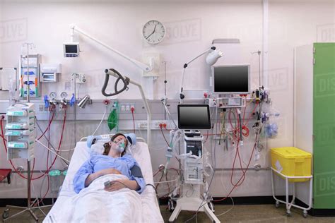 High Angle View Of Female Patient Sleeping On Bed In Hospital Stock