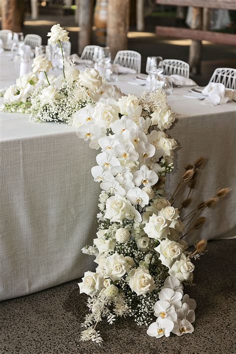 Modern White Wedding Style With Babies Breath Phalaenopsis Orchids
