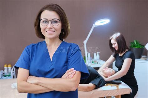 Portrait Of Woman Cosmetologist Doctor With Crossed Arms At Beauty