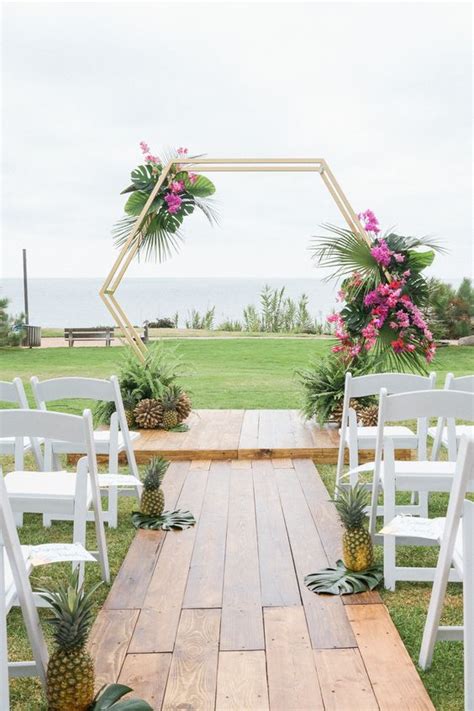 A romantic wedding arch with flowers and beads a perfect combination of macrame and tropical flowers a bright colorful ribbon and flowers arch 25 Bold Tropical Wedding Arches And Altars - Weddingomania