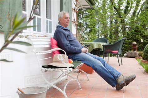 Older Man Sitting On Porch Stock Photo Dissolve