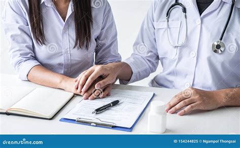 Image Of Doctor Holding Patient Hand To Encourage Talking With Patient