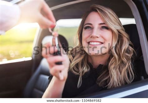 An Attractive Woman In A Car Gets The Car Keys Rent Or Purchase Of