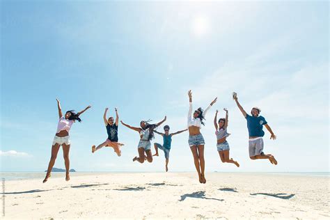 Group Of Happy People Jumping On A Tropical Beach By Lumina