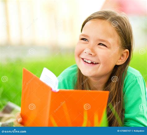 Little Girl Is Reading A Book Outdoors Stock Image Image Of Playful