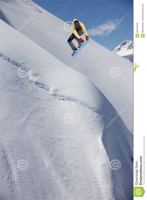 Extreme Winter Sport Snowboarder Jumping In Snowy Mountains Stock