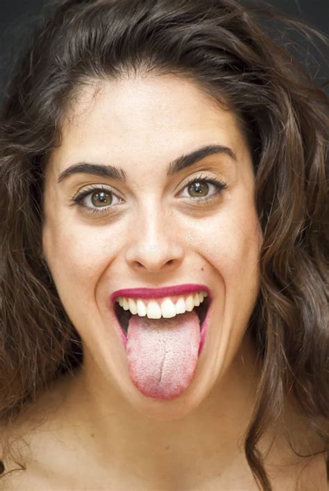 Portrait Of Beautiful Young Woman With Her Tongue Out Stock Photo